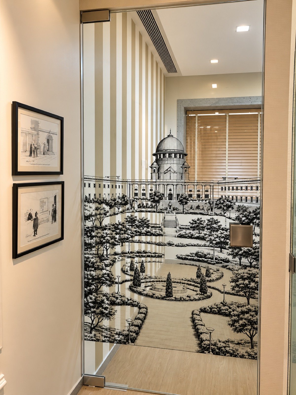 Glass door with an etched-look garden scene, framed prints on the wall beside it
